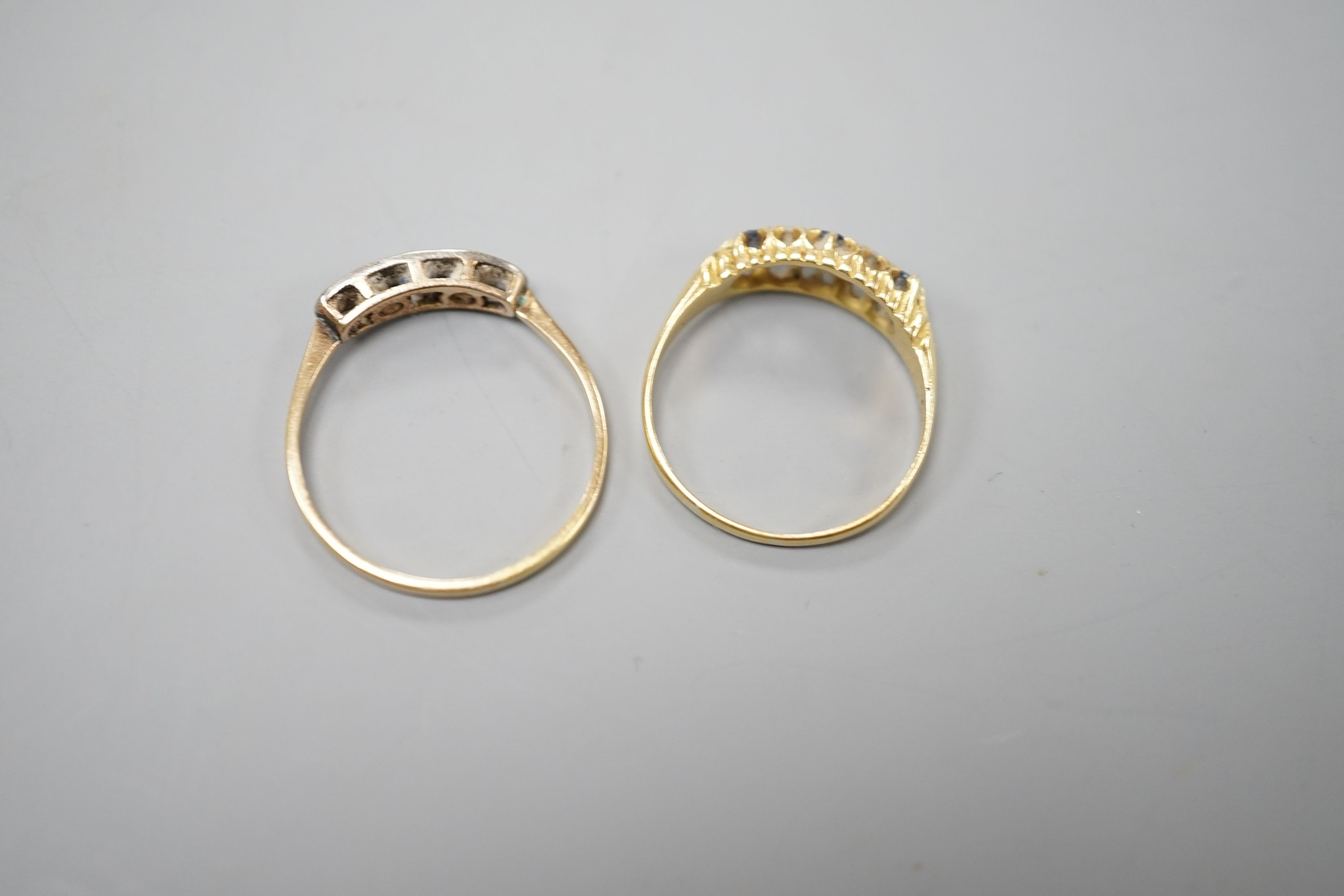 Two early 20th century yellow metal, sapphire and diamond set half hoop rings, sizes P & T, gross weight 5 grams.